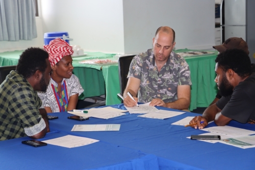 Media participants taking part in group work during the training.